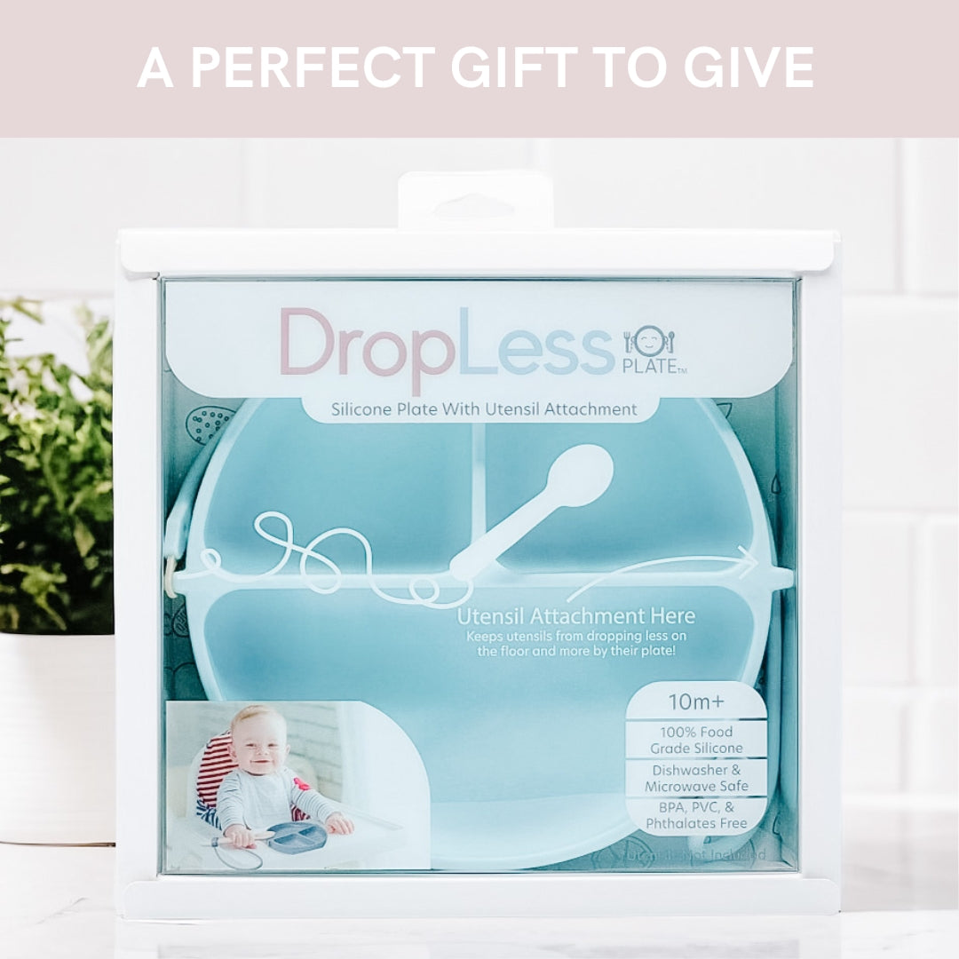 Boxed 'DropLess' silicone plate with utensil attachment on a white background