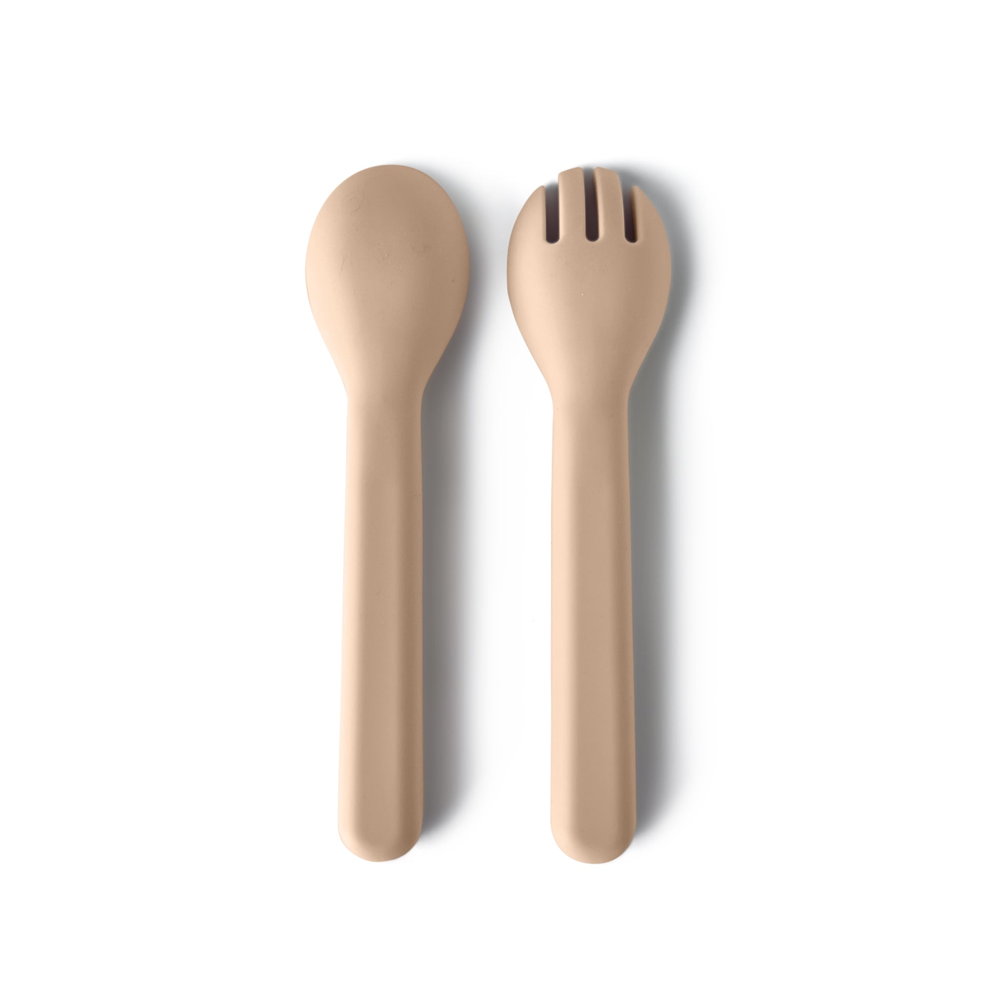 Beige silicone spoon and fork set on a white background